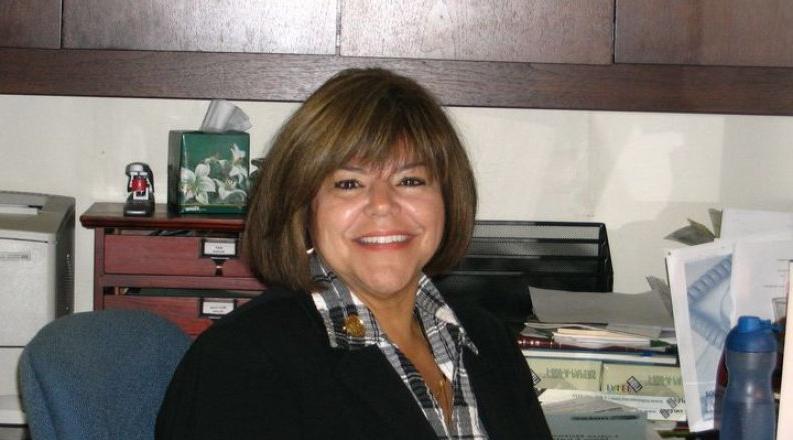 a woman sits at her desk